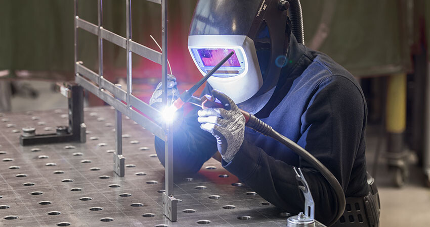 Ein Schlosser bei der Seemann Gestellbau GmbH schweißt ein Gestell aus Titan